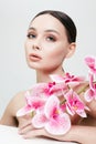 Beautiful young Woman with Flowers. Beauty Portrait of Girl with Orchid flower Royalty Free Stock Photo