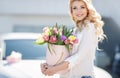 Beautiful young woman with flowers bouquet at city street. Royalty Free Stock Photo