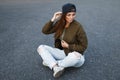 Beautiful young woman with freckles in a black baseball cap Royalty Free Stock Photo