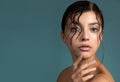 Beautiful young woman with fresh clean perfect skin. Portrait of beauty model with natural make up with wet skin and hair and hand Royalty Free Stock Photo