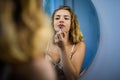 A Beautiful Young Woman In Front Of A Mirror Colors Lips Lipstick Royalty Free Stock Photo