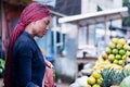 Beautiful young woman at the fruit market of the street Royalty Free Stock Photo