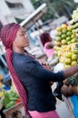 Beautiful young woman at the fruit market of the street Royalty Free Stock Photo
