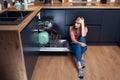 Beautiful young smiling woman doing dishes in the kitchen Royalty Free Stock Photo