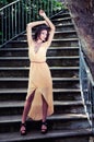 Beautiful young woman in a garden stairs. Royalty Free Stock Photo