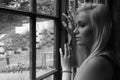 Beautiful young woman gazing out of a window Royalty Free Stock Photo