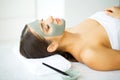 Beautiful Young Woman Getting a Face Treatment at Beauty Salon.Skin and care. Beautiful Woman Lying With Face Mask. Pure and Beaut Royalty Free Stock Photo