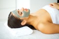 Beautiful Young Woman Getting a Face Treatment at Beauty Salon.Skin and care. Beautiful Woman Lying With Face Mask. Pure and Beaut Royalty Free Stock Photo