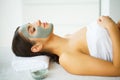 Beautiful Young Woman Getting a Face Treatment at Beauty Salon.Skin and care. Beautiful Woman Lying With Face Mask. Pure and Beaut Royalty Free Stock Photo