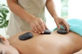 Beautiful young woman getting hot stone massage Royalty Free Stock Photo