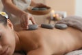 Beautiful young woman getting hot stone massage Royalty Free Stock Photo