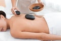 Beautiful young woman getting hot stone massage Royalty Free Stock Photo