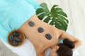 Beautiful young woman getting hot stone massage in spa salon Royalty Free Stock Photo