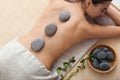 Beautiful young woman getting hot stone massage Royalty Free Stock Photo