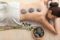 Beautiful young woman getting hot stone massage in spa salon Royalty Free Stock Photo