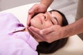 Beautiful Young Woman Getting A Jaw Massage Royalty Free Stock Photo