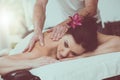 Beautiful young woman getting massage, light effect Royalty Free Stock Photo