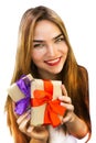 Beautiful young woman with gifts with red and purple ribbons