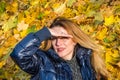 Beautiful young woman girl happy mother playing with her daughter smiling and holding a yellow maple leaves walking in autumn park Royalty Free Stock Photo