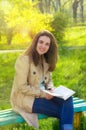 Beautiful young woman girl smiling reading a book Royalty Free Stock Photo