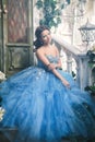 Beautiful young woman in gorgeous blue long dress like Cinderella with perfect make-up and hair style Royalty Free Stock Photo