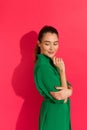 Beautiful young woman in green dress is looking over shoulder Royalty Free Stock Photo