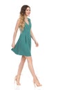 Beautiful Young Woman In Green Mini Dress And High Heels Is Walking. Front Side View Royalty Free Stock Photo