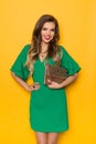 Beautiful Young Woman In Green Mini Dress Is Posing With Sequin Cluth Bag Royalty Free Stock Photo