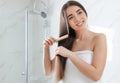 Beautiful young woman with hair brush Royalty Free Stock Photo