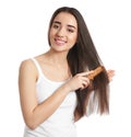 Beautiful young woman with hair comb on white
