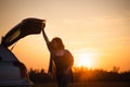 Beautiful young woman happy and dancing in a car`s trunk during a road trip in Europe in the last minutes of Golden Hour Royalty Free Stock Photo