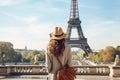 Beautiful young woman in hat and coat looking at Eiffel tower in Paris, France, Female tourist sightseeing the Eiffel tower and