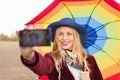 Beautiful young woman in hat holding umbrella and Royalty Free Stock Photo