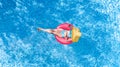 Beautiful young woman in hat in swimming pool aerial top view from above, girl in bikini relaxes and swim on inflatable ring donut Royalty Free Stock Photo