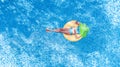 Beautiful young woman in hat in swimming pool aerial top view from above, girl in bikini relaxes and swim on inflatable ring donut Royalty Free Stock Photo