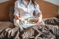 Woman have a romantic Breakfast in cozy morning bed. Coffee and word love from cookies. Surprise on Valentine`s day Royalty Free Stock Photo