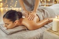 Beautiful young woman having back massage in spa salon Royalty Free Stock Photo