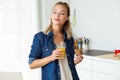 Beautiful young woman having breakfast in the kitchen. Royalty Free Stock Photo