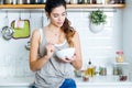 Beautiful young woman having breakfast in the kitchen. Royalty Free Stock Photo