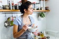 Beautiful young woman having breakfast in the kitchen. Royalty Free Stock Photo