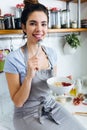 Beautiful young woman having breakfast in the kitchen. Royalty Free Stock Photo