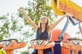 Beautiful, young woman having fun at an amusement park Royalty Free Stock Photo