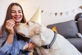 Woman giving treats to her dog while celebrating his birthday Royalty Free Stock Photo