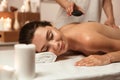 Beautiful young woman having hot stone massage Royalty Free Stock Photo