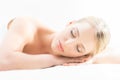 Beautiful young woman having leisure lying in a mat in spa Royalty Free Stock Photo