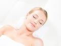 Beautiful young woman having leisure lying in a mat in spa Royalty Free Stock Photo