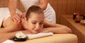 Beautiful young woman having a massage treatment in spa salon - wellness Royalty Free Stock Photo