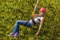 Young woman after the bungee jump against green foliage Royalty Free Stock Photo