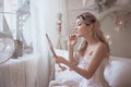 Beautiful young woman in her bedroom with a mirror. Bride`s morning or vintage boudoir