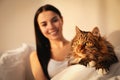 Beautiful young woman with her cute cat on bed Royalty Free Stock Photo